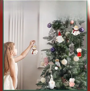 Close-up of plush Christmas tree ornaments including snowman, owl, and gnome figurines