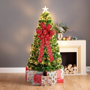 Close-up of a green fiber optic Christmas tree decorated with a large red glitter bow