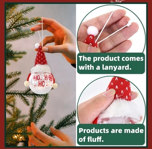 Detail of Christmas snowman ball ornament with HO HO HO text and hanging lanyard on tree