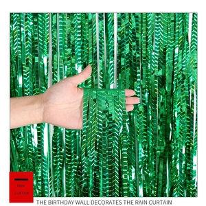 Detailed close-up of metallic green foil fringe curtain texture for party backgrounds