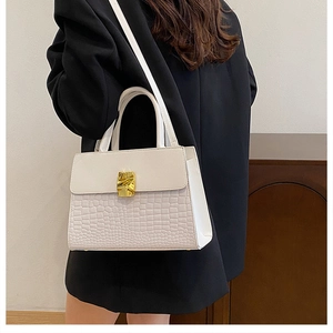 Detailed back view of model wearing white leather crossbody bag with crocodile texture