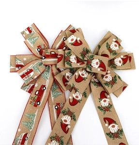 Macro detail of faux linen Christmas bow with vintage truck and gnome printed patterns