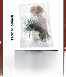 Detail of Christmas owl ornament with silver sequins, pine needles, and star bell