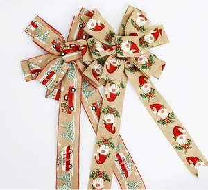 Detail of Christmas bow with gnome and red truck print on imitation linen fabric