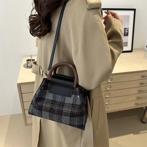 Chic autumn plaid woolen bucket bag with leather handles shown in a lifestyle setting