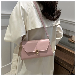 Detailed shot of a pink PU leather flap bag with a stylish golden ring lock ornament