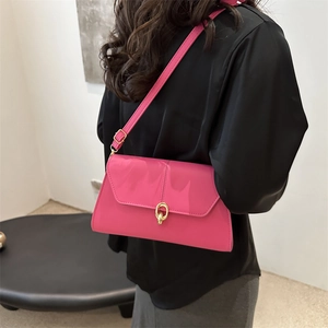 Pink patent leather underarm bag with gold ring buckle and adjustable shoulder strap