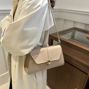 Chic beige cream underarm shoulder bag with gold buckle lock and minimalist leather design
