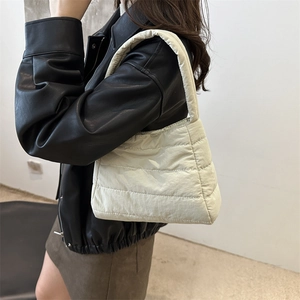 Quilted puffer shoulder bag in beige featuring a minimalist lightweight nylon design