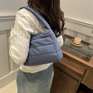 Blue quilted puffer shoulder bag for women with padded strap and minimalist cloud design