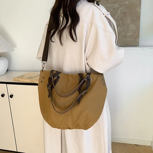 Retro canvas tote bag in tan with leather handles and long shoulder strap for women