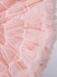 Detailed close-up of layers of soft pink pleated tulle on a puffy ballerina tutu skirt