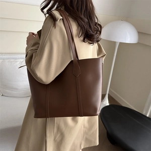 Retro dark brown synthetic leather tote bag for women showing a minimalist shoulder design