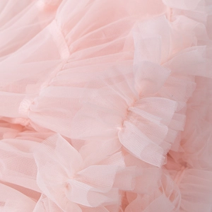 Macro shot of layered pink tutu skirt mesh fabric with delicate ruffled edge details