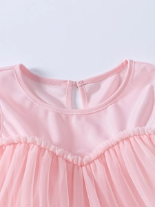 Détail de l'encolure de la robe tutu rose avec mesh et fermeture à bouton au dos