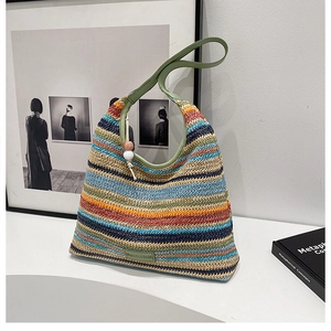 Detail of multi-color striped woven tote with green strap and decorative wooden bead