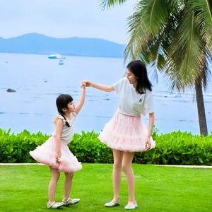 Outdoor shot of mother and daughter in pink layered tulle skirts with white t-shirts