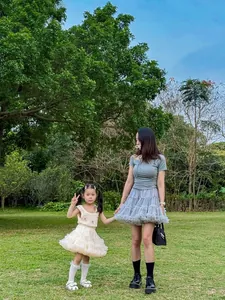 Detail of crochet top with flower accents and layered tulle tutu skirt for mothers and daughters