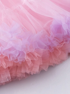 Detail of pink and purple tiered mesh tutu skirt with delicate ruffled edges for kids