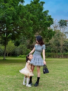 Parent-child fashion set featuring tiered mesh tutu skirts for adult and young girl