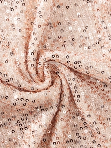 Macro shot of rose gold sequins on mesh fabric showing metallic shine and texture