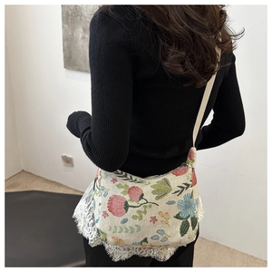 Floral embroidered canvas tote bag shown from behind on a model for daily commuting