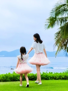 Pink multi-layer tulle tutu skirt for women and girls in a scenic outdoor beach setting