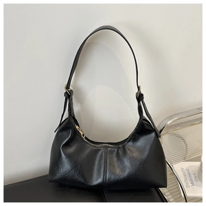 Close-up of black hobo bag with adjustable gold buckle and smooth leather texture
