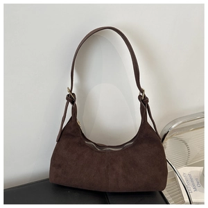 Detailed view of deep brown suede hobo bag with metal zipper and adjustable strap