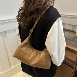 Vintage brown hobo shoulder bag for women with natural leather texture and adjustable strap