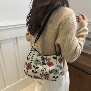 Minimalist floral canvas tote bag with adjustable black strap worn by a woman