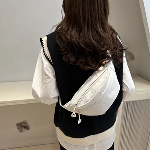 Minimalist white canvas sling bag with grid texture and dual zipper detail for women