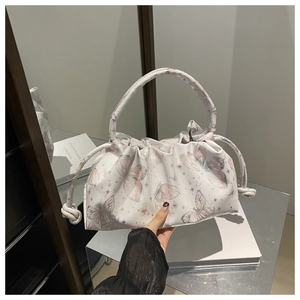 Detail of white butterfly print ruched cloud bag with drawstring and tubular handle