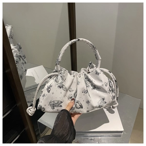 Detail of white PU cloud bag with butterfly print, featuring pleated texture and round handle