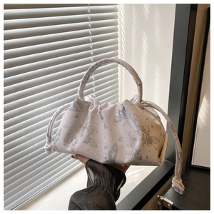 Detail of light beige pleated cloud bag with gray butterfly print and drawstring
