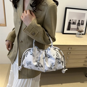 White butterfly print ruched shoulder bag with rope knot handle in minimalist setting