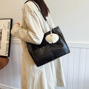 Large black tote bag with chain strap and plush charm for women's autumn commute fashion