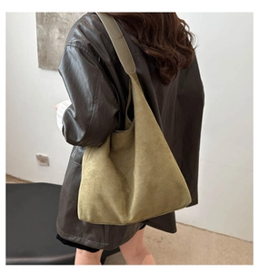 Detailed back view of a large olive green suede tote bag showing soft matte texture