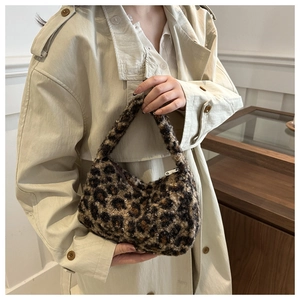 Macro shot of fluffy leopard print tote with silver metal zipper and soft plush texture