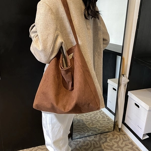 Brown faux suede oversized tote bag shown on model for a casual and stylish commute look