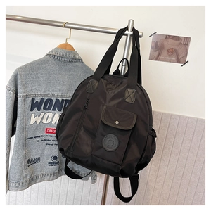 Detail of black versatile travel backpack with multiple pockets and functional shoulder straps