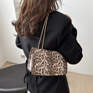 French vintage leopard print crossbody bag with gold chain strap shown on model back