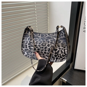 Detailed view of leopard print hobo bag with sleek crescent shape and gold hardware