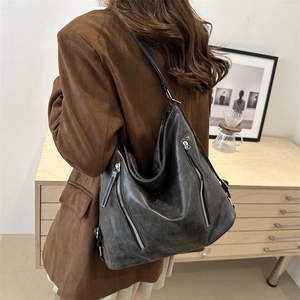 Large black vintage hobo tote bag with silver zippers and soft leather texture