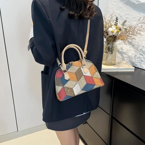 Fashionable shell-shaped tote bag with colorful geometric patchwork and adjustable strap