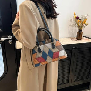 Fashionable multi-color geometric patchwork shell handbag with black top handles and strap