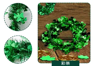 Detail of green St. Patrick's Day tinsel garland with shamrock accents on wooden surface