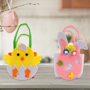 Detail of Easter non-woven chick and bunny gift bags on light wood surface