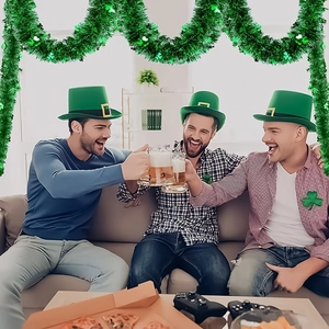 St. Patrick's Day party set with green tinsel garland, shamrock hats and clover pins