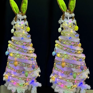 White Easter tree with LED lights, golden ribbons, colorful eggs, and rabbit ears decoration
